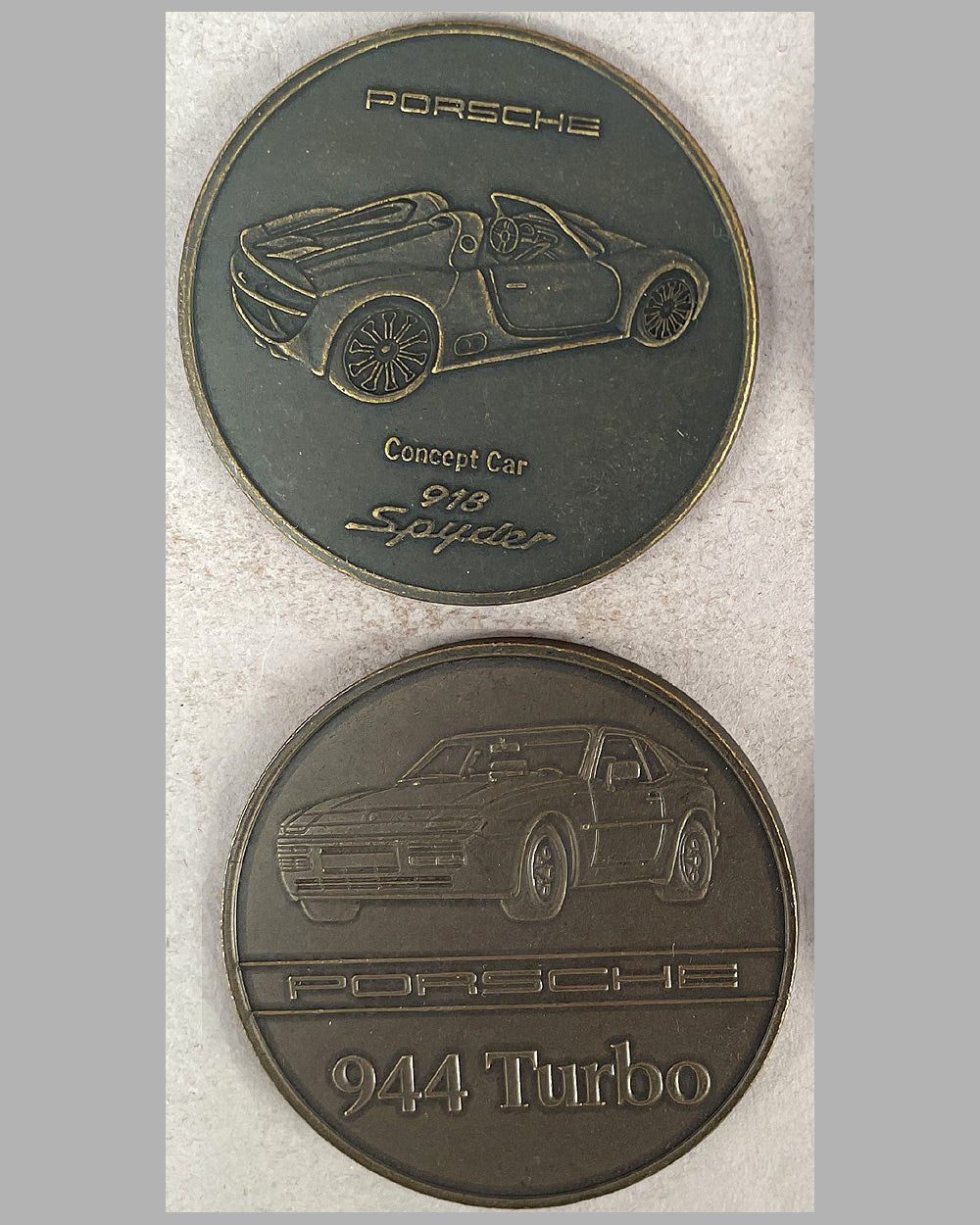 Four yearly bronze coins from the Porsche factory, 1983, 1986, 1988, and 2011 2