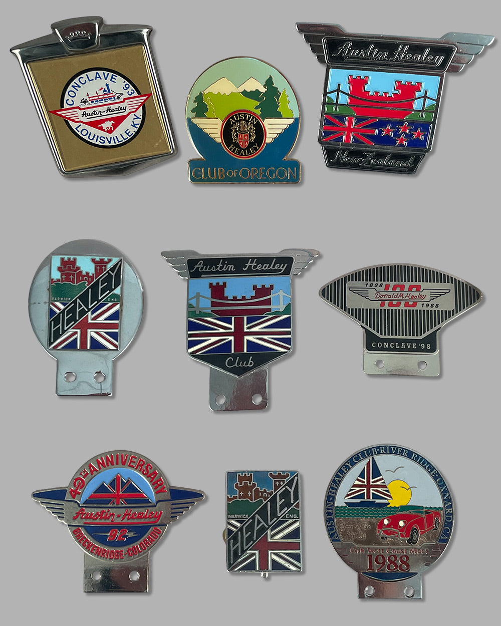 Collection of 9 Austin Healey club grill or bumper badges