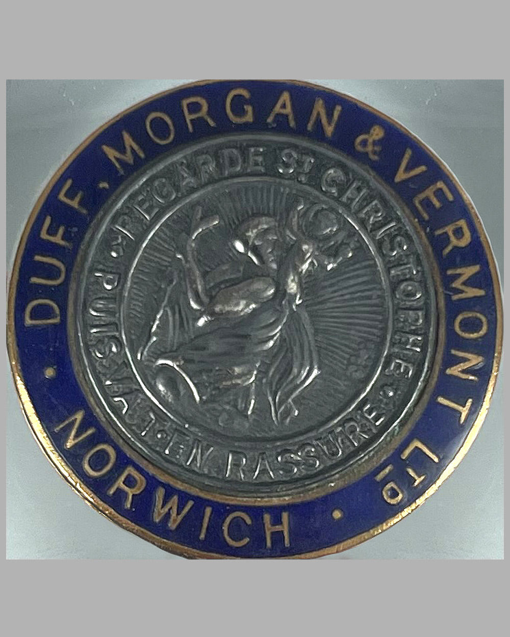 Saint Christopher medal mounted on a U.K. registration window sticker 2