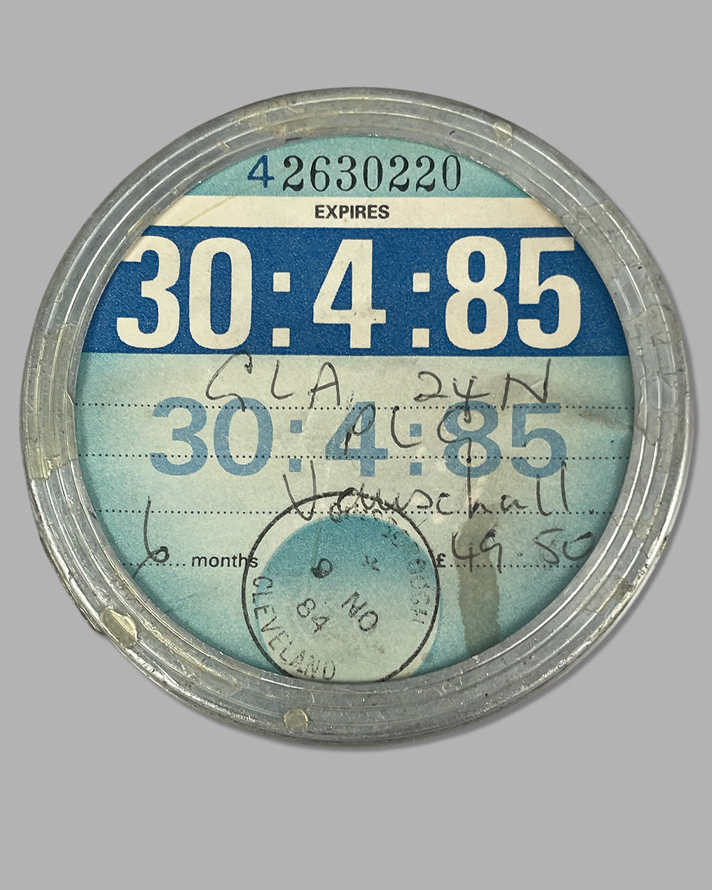 Saint Christopher medal mounted on a U.K. registration window sticker 3