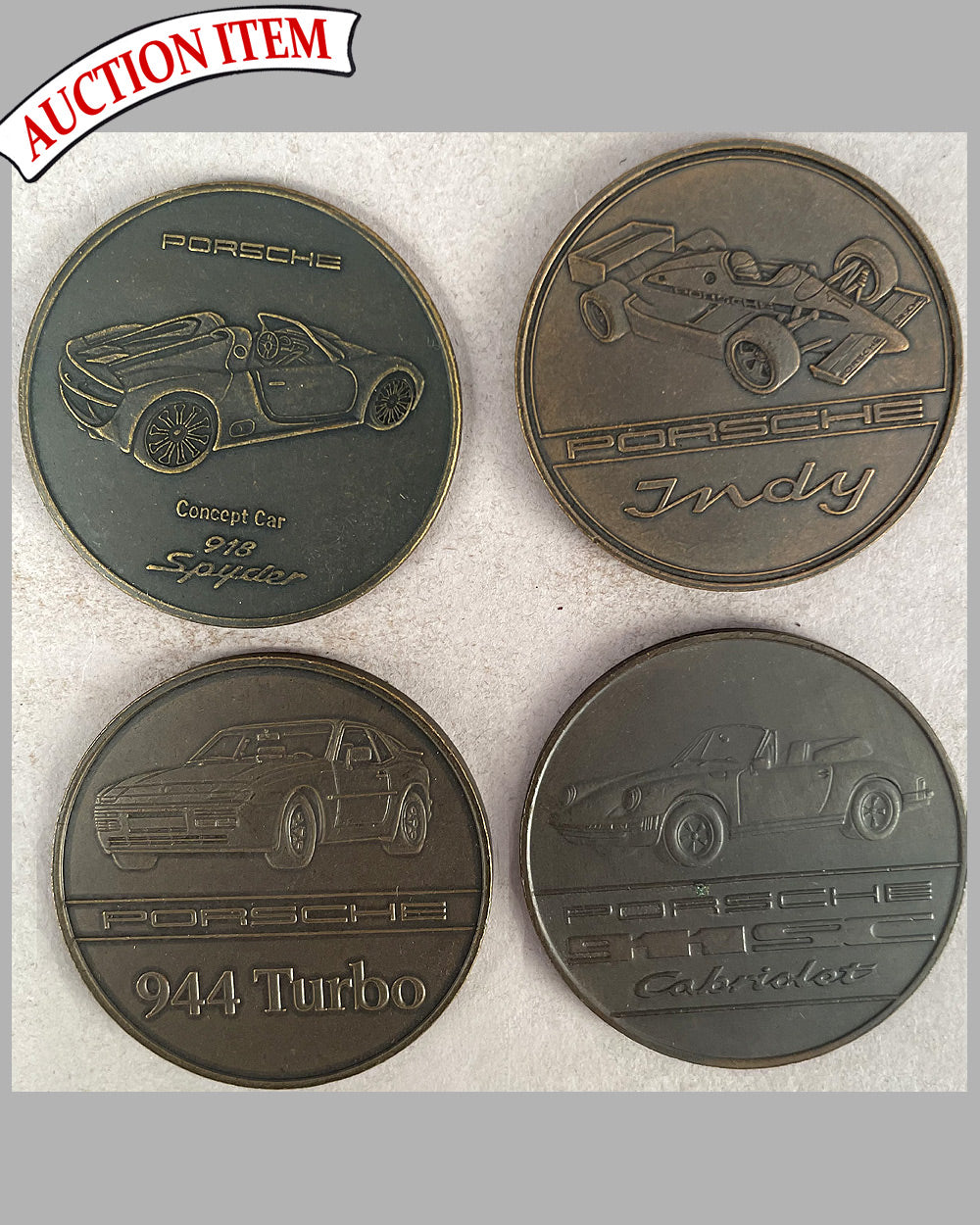 Four yearly bronze coins from the Porsche factory, 1983, 1986, 1988, and 2011