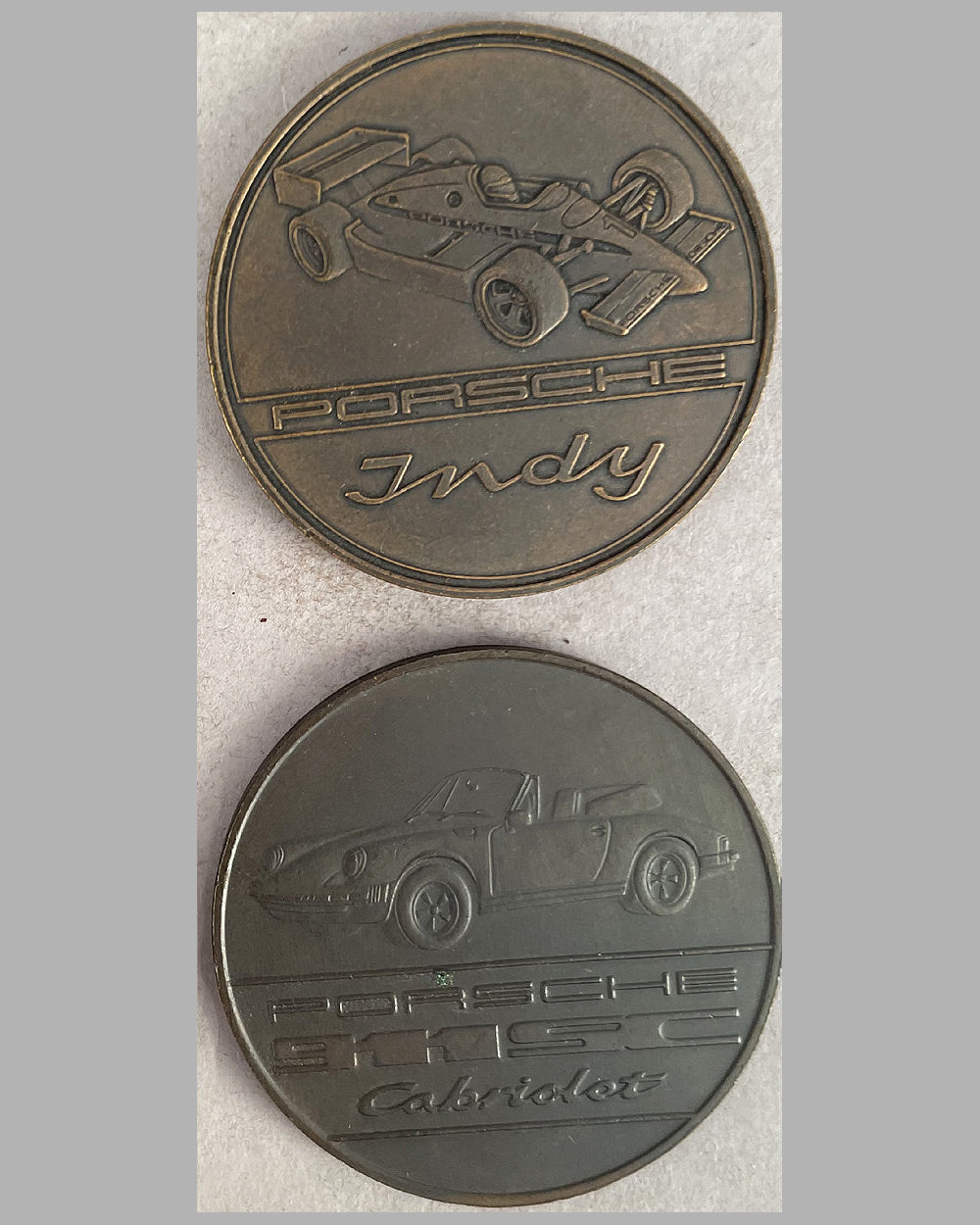 Four yearly bronze coins from the Porsche factory, 1983, 1986, 1988, and 2011 3