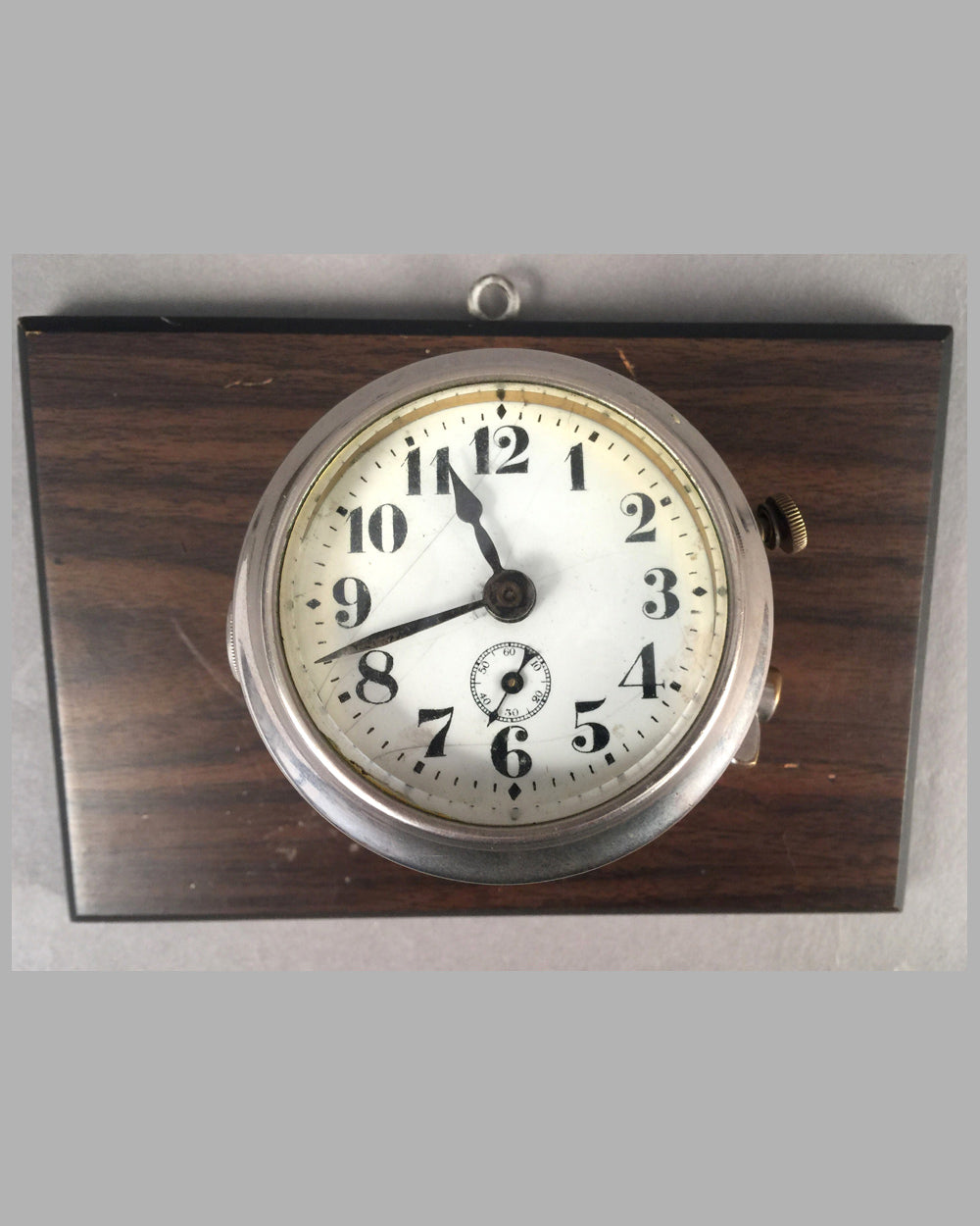 Eight day yacht clock mounted on wooden base for hanging