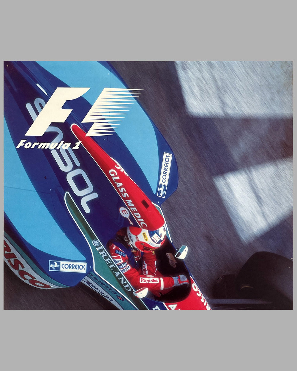 Formula 1 car with multiple brand logos on a gray background