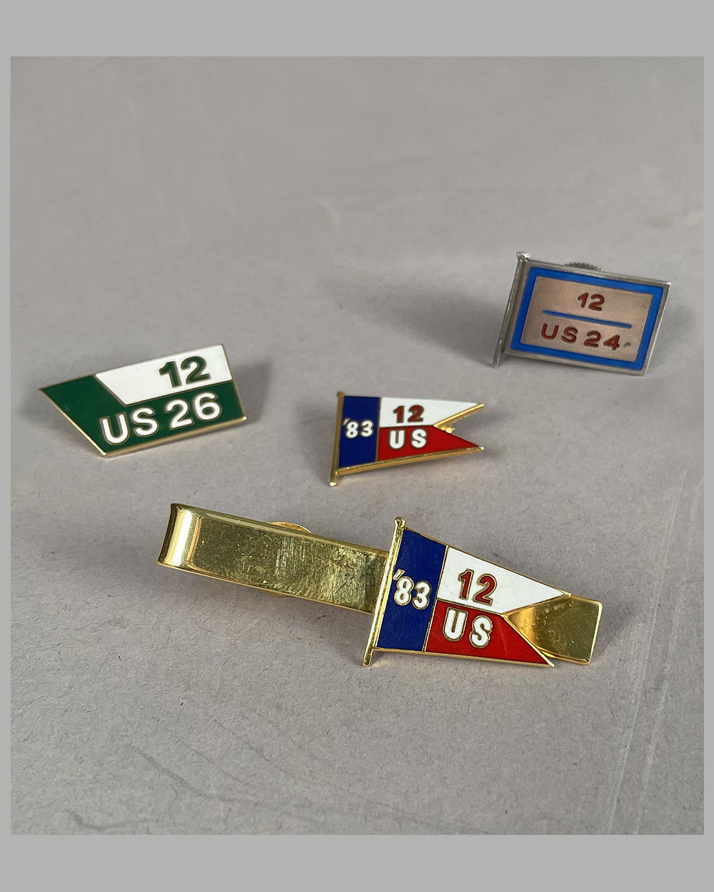 Three America's Cup lapel pins and one tie clip from the personal