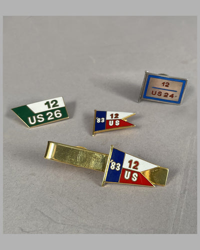 Three America’s Cup lapel pins and one tie clip from the personal collection of Briggs Cunningham