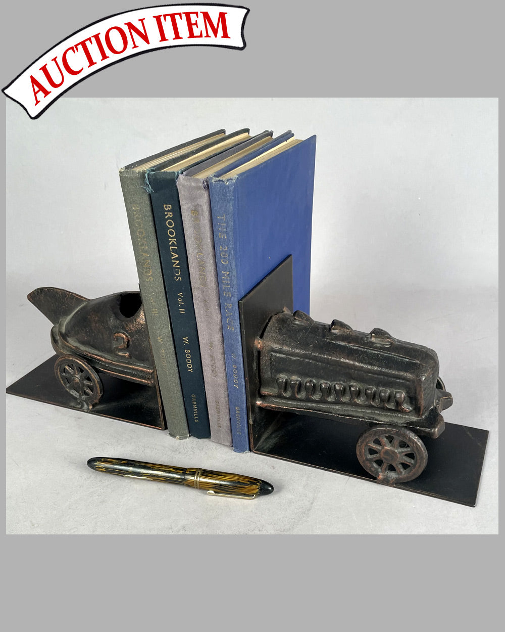 Pair of bronze book ends with primitive racing car motif