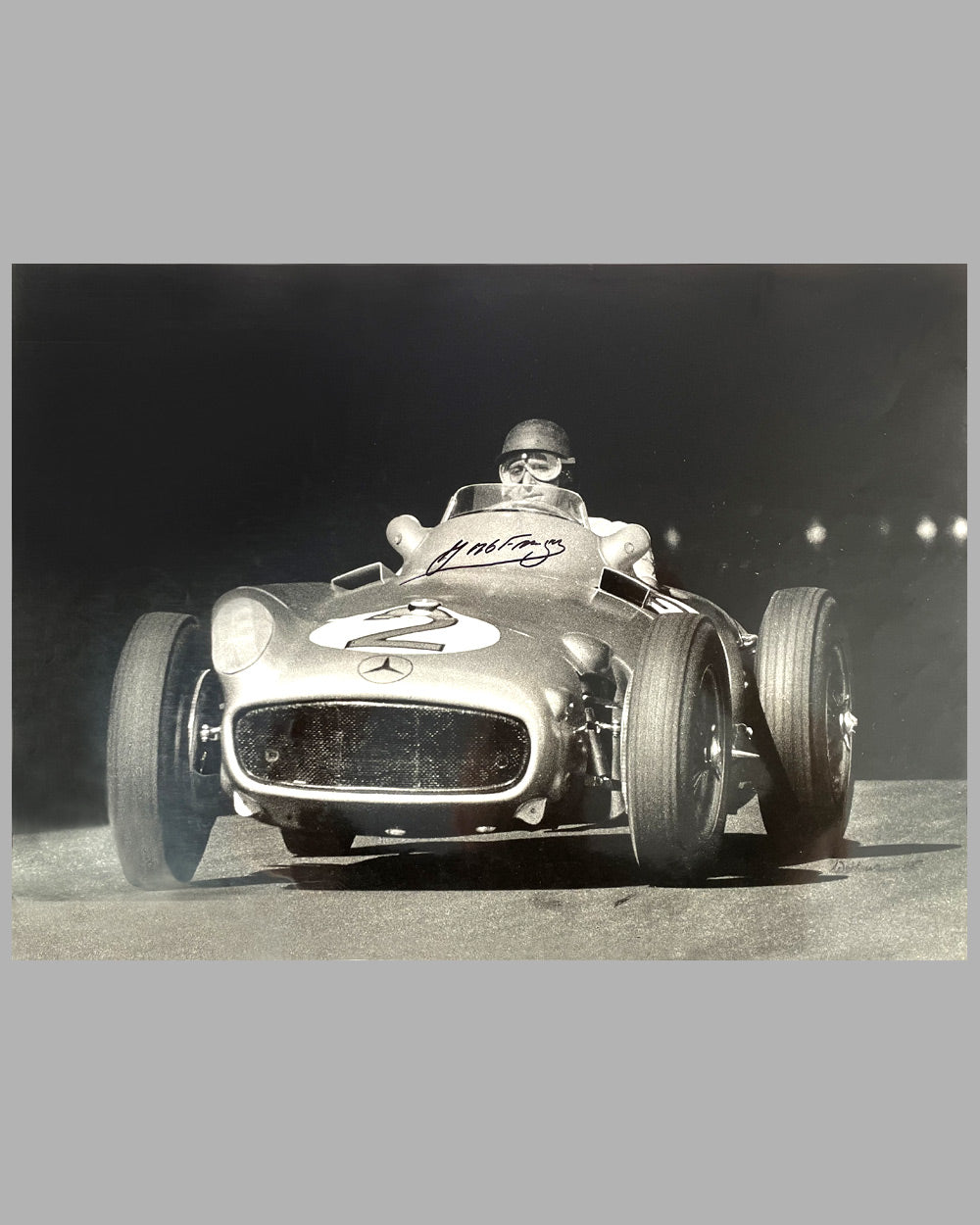 Juan Manuel Fangio at speed b&amp;w photograph, hand autographed by Fangio