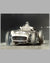 Juan Manuel Fangio at speed b&w photograph, hand autographed by Fangio