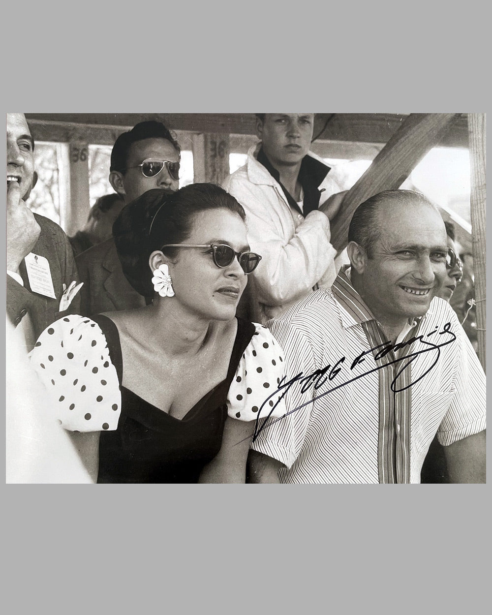 Juan Manuel Fangio in good company on the pit wall b&amp;w photo, hand autographed by Fangio