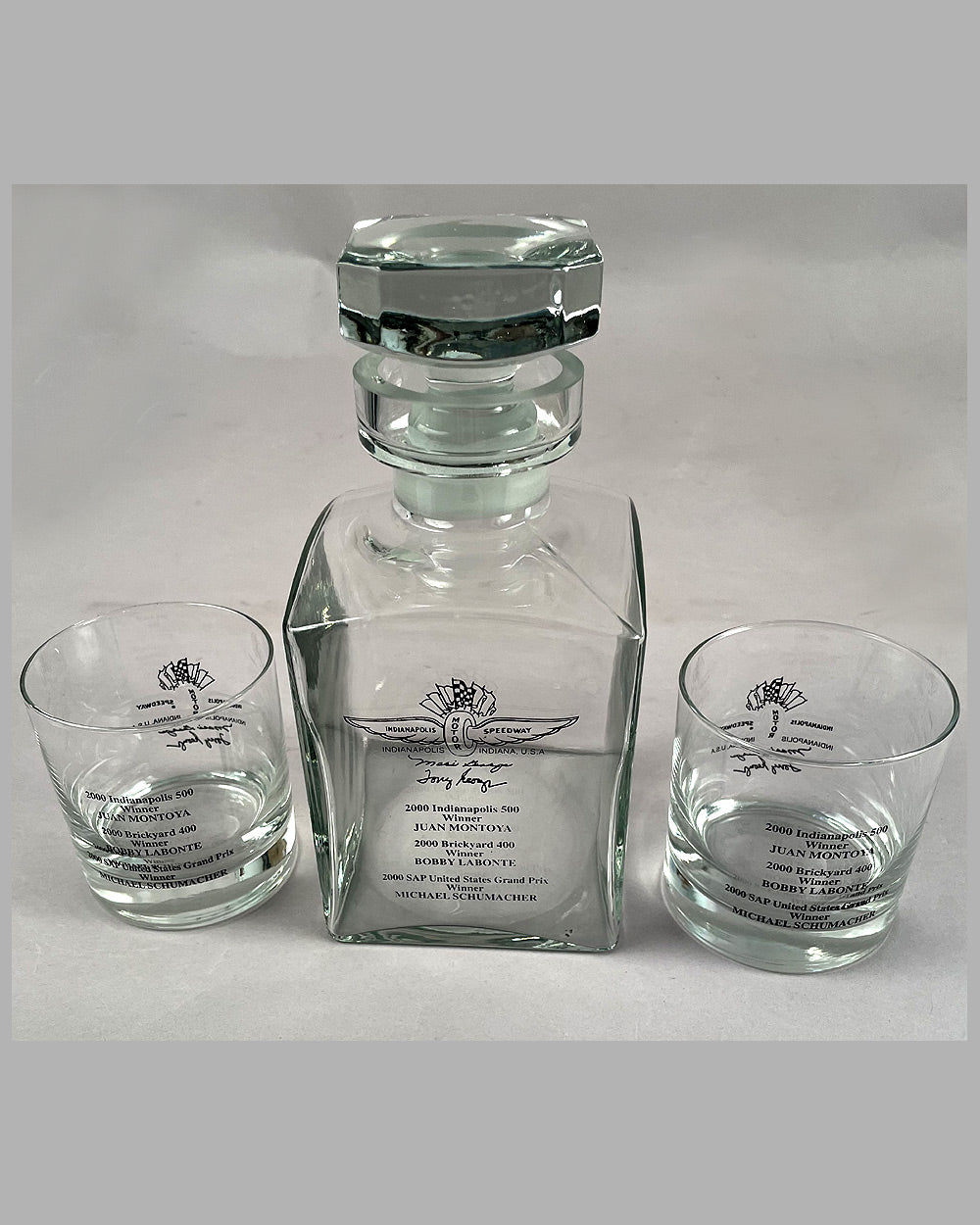 Set of Indianapolis Motor Speedway (IMS) whiskey glasses and decanter celebrating 3 wins in 2000 5
