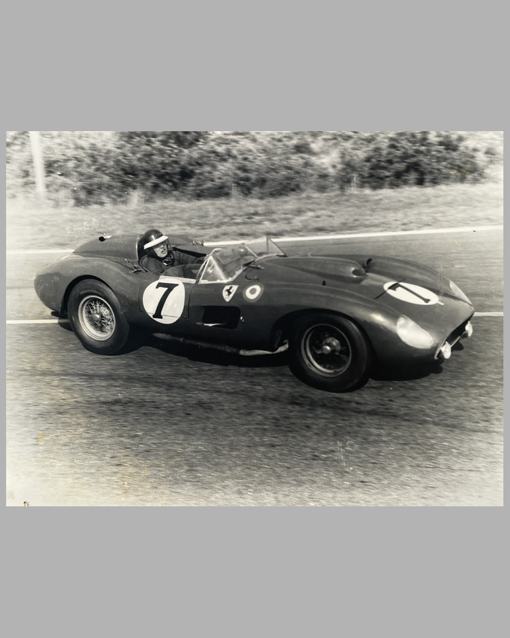 Mike Hawthorn wheeling his Ferrari at Le Mans in 1957, photograph