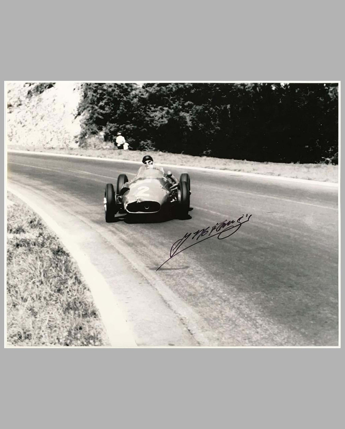 Juan Manuel Fangio in his Maserati 250 F autographed b&amp;w photograph