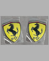 Two Scuderia Ferrari (SF) fender shields/badges
