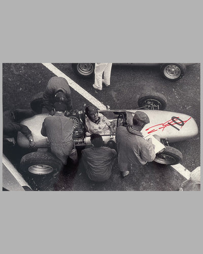Dan Gurney in his Porsche Formula 1 car in the pit, autographed photo